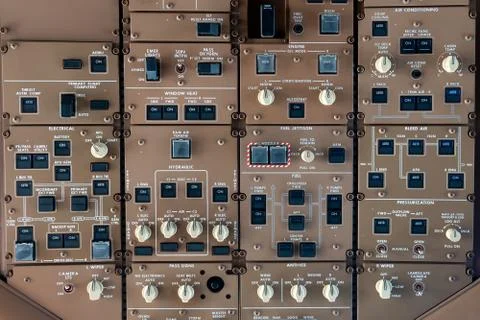 Control panel knobs and buttons in a big jet plane cockpit Stock Photos