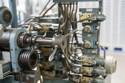 Control panel with manual wheel and connected machinery in a manufacturing .. Stock-Fotos