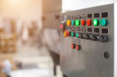 Control panel with multi-colored buttons to control production equipment and Фото