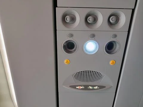 Control panel overhead and icons in economy class cabin Stock Photos