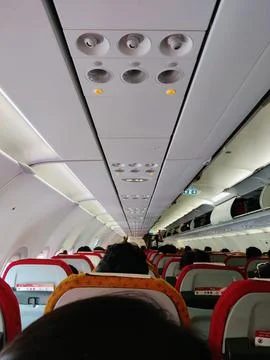 Control panel overhead and icons in economy class cabin Stock Photos