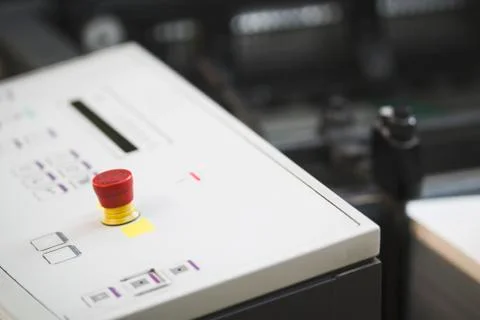 Control panel with red button of the print press machine Stock Photos