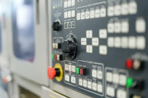 Control panel shows buttons and knobs used for machine operation in a facto.. Stock-Fotos