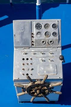 Control panel with steering wheel and gauges on ship deck 库存照片