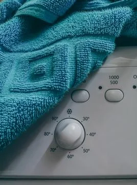 Control panel of the washing machine under a blue towel. Selective focus Stock Photos