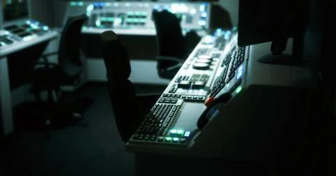 Control room with dim lighting and illuminated equipment at night Stock Illustration