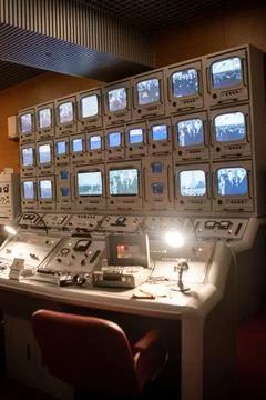 Control Room With Multiple Monitors Displaying Different Channels in an Old Stock Photos