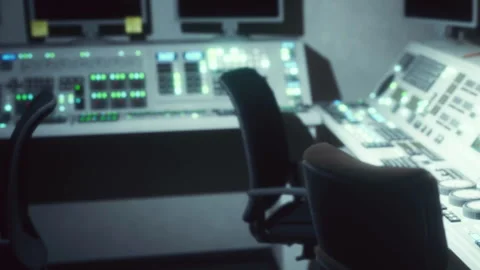 Control room with multiple screens and console in a technical setting Stock Footage 344985307