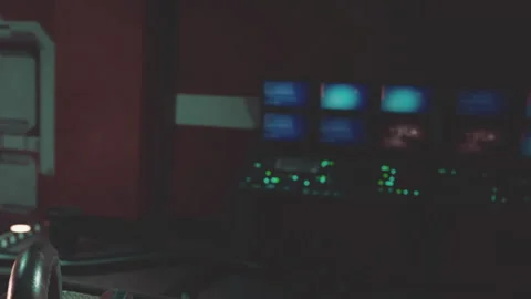 Control room with multiple screens showing digital displays at night Stock Footage 345054848
