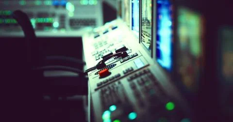 Control room panel displays lights and switches during late night operations Illustrazione stock