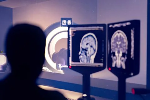 In Control Room Radiologist Diagnosis while Watching Procedure and Monitors.. Illustrazione stock