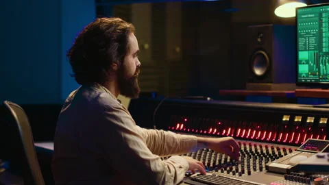 Control room sound engineer editing music with sliders and knobs 스톡 동영상 270504633