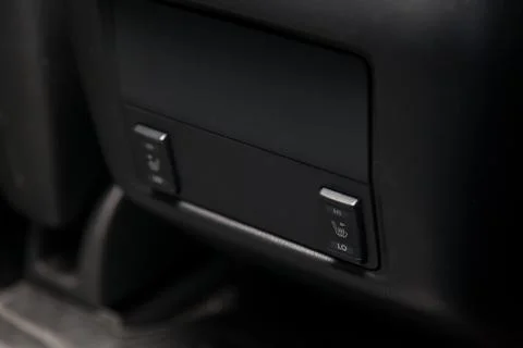 Control switch heated two rear seats on the car dashboard with plastic button Stock Photos