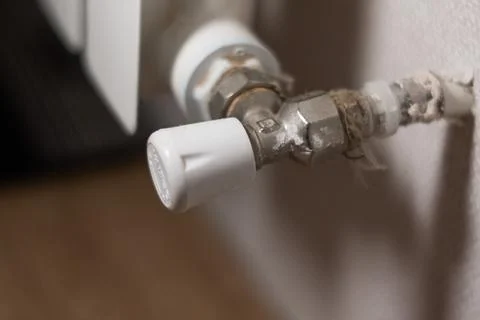 Control valve on the heating radiator in the apartment Stock Photos