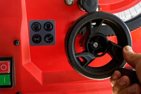 Controling and regulating red electrical table saw Stock Photos
