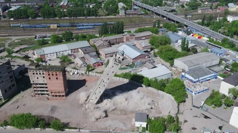 Controlled demolition of an old building. The tall tower falls and shatters Stock Footage 154473911