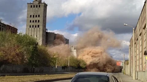 A controlled explosion of an old building. Highly dusty air after explosion. Stock Footage 143133149