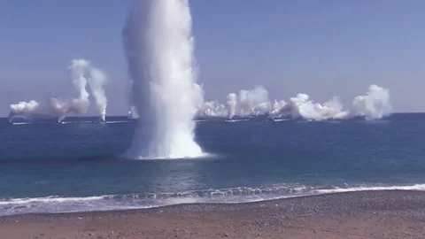 Controlled explosion underwater near a beach Stock Footage 105479140