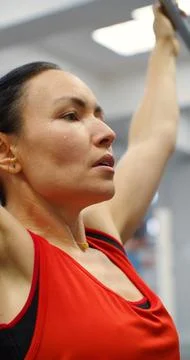 Controlled pulldown reps target the lats during this gym workout session. Stock Photos