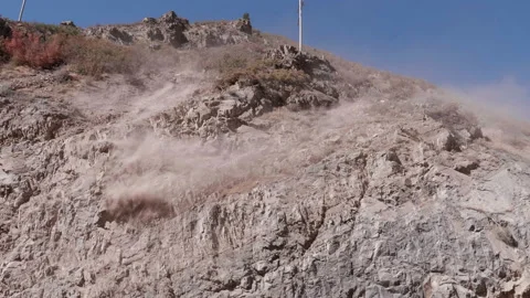 Controlled Rockslide Off a Cliff Stock Footage 145175112