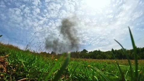 Controlled TNT Explosion in Open Field with Debris and Smoke Cloud Stock Footage 283576371