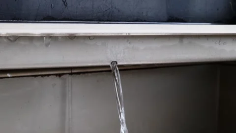Controlled water flow through a fine hole in the gutter. A hydrotechnical p.. Stock Footage 244655395