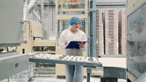 Controller checking conveyor with candies. Candy factory. Stock Footage 98018090