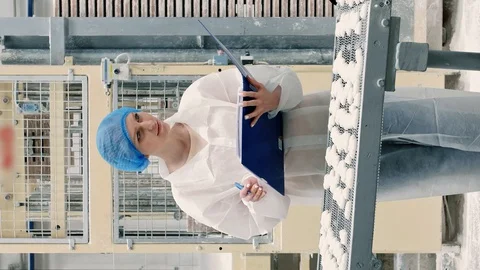 Controller checking conveyor with candies. Candy factory. Stock Footage 129878546