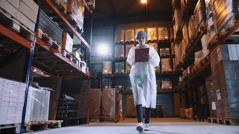 Controller checking factory storage room. Candy factory. Stock Footage 98030723