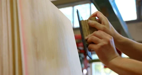 Controller puts a stamp on a sheet of plywood confirming a quality of a sample Stock Footage 105980817