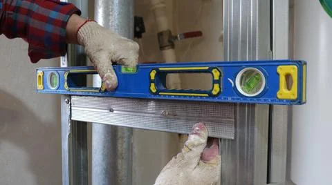 Controlling the accuracy of metal frame installation with a level Photos