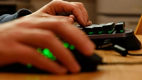 Controlling the game using a modern gaming rgb mouse and a mini keypad. Stock-Footage 164932517
