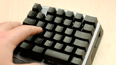 Controlling the game using a modern gaming rgb mini keypad. Video stock 164932528