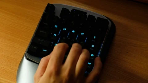 Controlling the game using a modern gaming mini keypad. 스톡 동영상 164932552