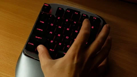 Controlling the game using a modern gaming rgb mini keypad. Stock-Footage 164932554