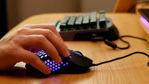 Controlling the game using a modern gaming rgb mouse and a mini keypad Stock-Footage 164932584
