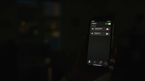 Controlling home lights wirelessly using smartphone / Smart Home Features Stock Footage 103184734