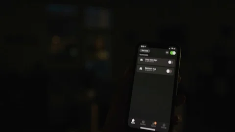 Controlling home lights wirelessly using smartphone / Smart Home Features Stock Footage 103184821