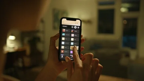 Controlling home lights wirelessly using smartphone / Smart Home Features Stock Footage 103185212