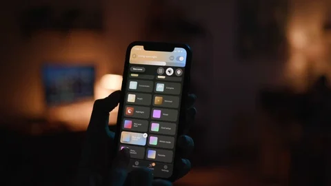 Controlling home lights wirelessly using smartphone / Smart Home Features Stock Footage 103185286