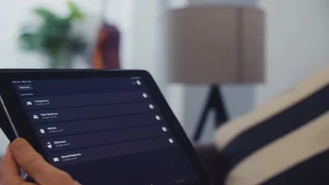 Controlling Smart Home Lights Wirelessly Using An Ipad / Smart Home Lights Stock Footage 131690506