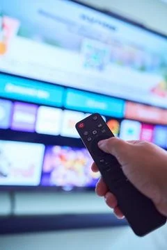 Controlling smart TV with remote device Stock Photos