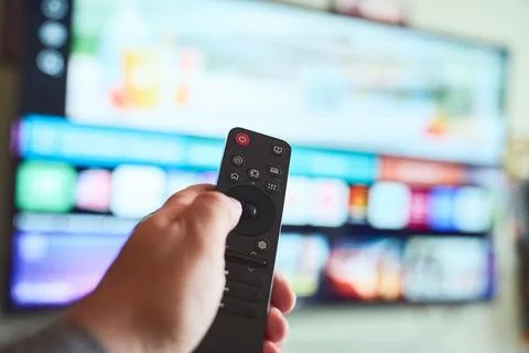 Controlling the smart TV with a remote Stock Photos