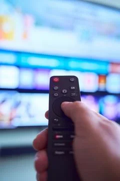 Controlling the smart TV with the remote Stock Photos