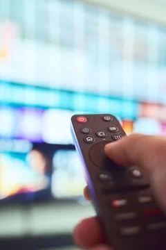 Controlling the television with a remote Stock Photos