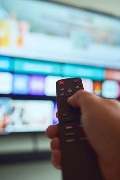 Controlling the television with a remote Stock Photos