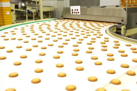 Controlling the work of huge conveyor machine producing spice cakes at the co Stock Photos