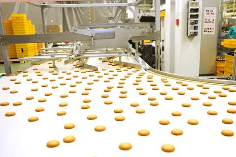 Controlling the work of huge conveyor machine producing spice cakes at the co Stock Photos