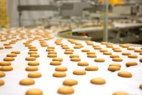 Controlling the work of huge conveyor machine producing spice cakes at the co Stock Photos