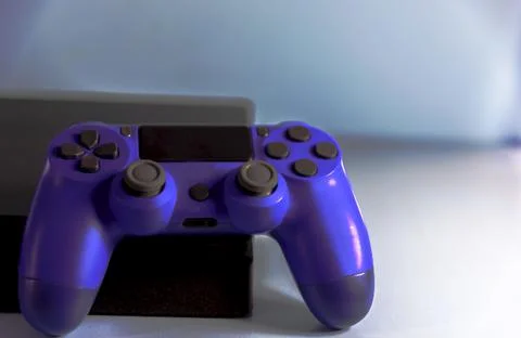 Controls and video game console on light background Stock Photos